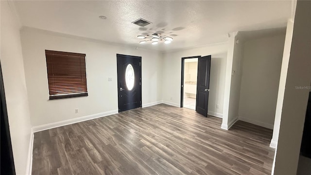 7017 Baywood Dr, Tampa, FL 33637 - entryway with a textured ceiling, visible vents, ceiling fan, dark wood-style floors, and baseboards