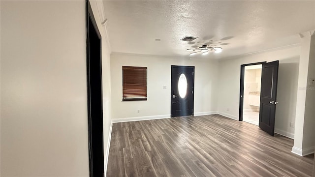 7017 Baywood Dr, Tampa, FL 33637 - foyer entrance with baseboards, visible vents, a textured ceiling, and wood finished floors