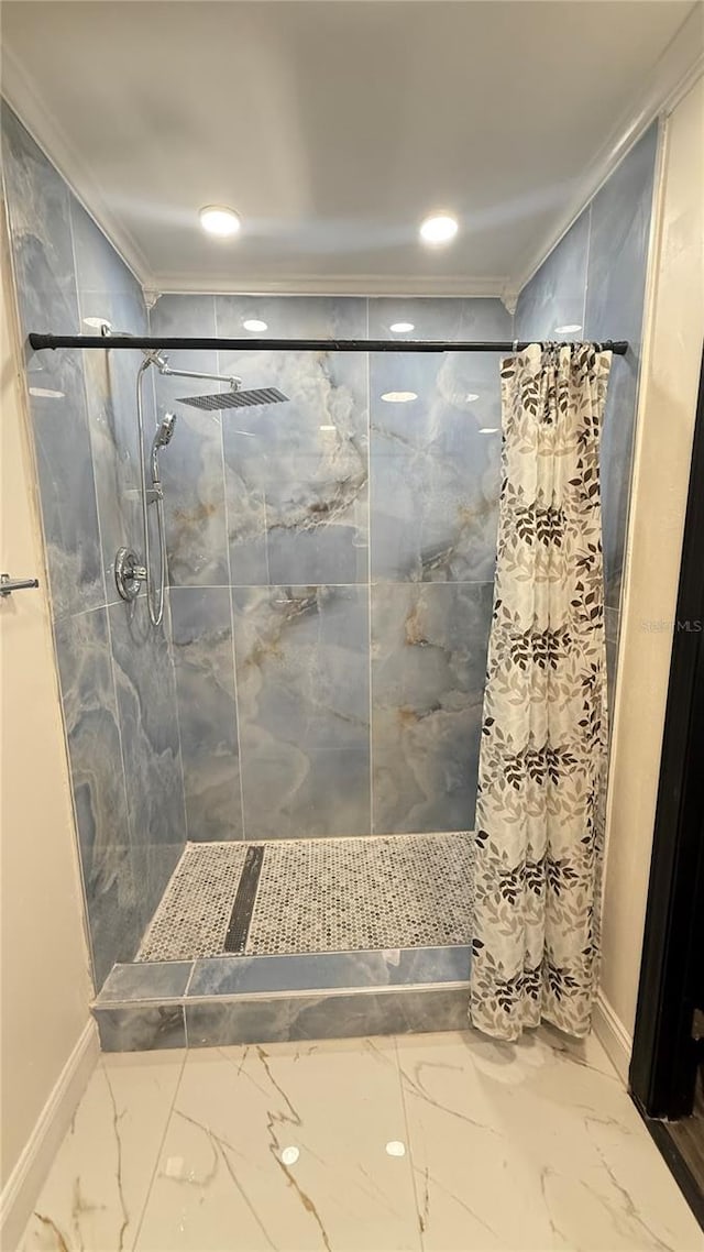 7017 Baywood Dr, Tampa, FL 33637 - bathroom featuring a stall shower, marble finish floor, baseboards, and crown molding