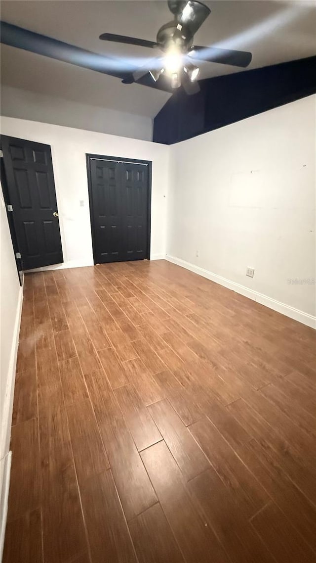 7017 Baywood Dr, Tampa, FL 33637 - interior space featuring vaulted ceiling, ceiling fan, baseboards, and wood finished floors