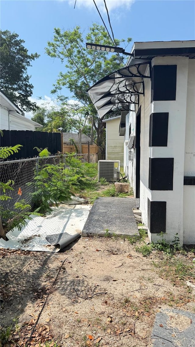 7017 Baywood Dr, Tampa, FL 33637 - view of yard with central AC and fence