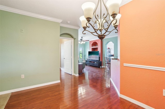 interior space featuring an inviting chandelier, arched walkways, baseboards, wood finished floors, and ornamental molding