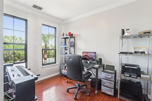 office with visible vents, crown molding, wood finished floors, baseboards, and a textured wall
