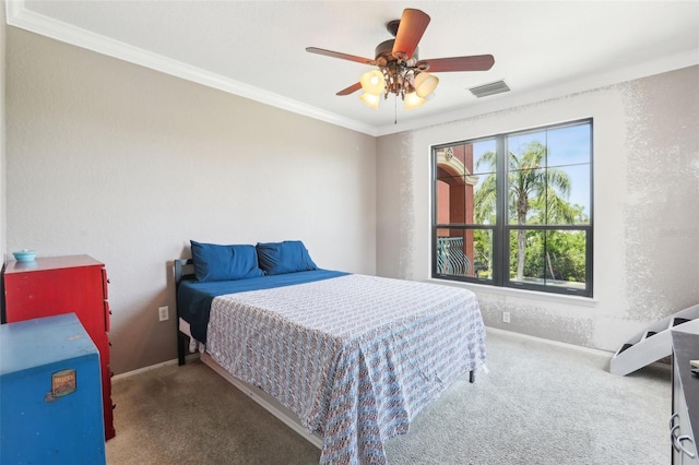 bedroom featuring visible vents, ornamental molding, carpet floors, baseboards, and a ceiling fan