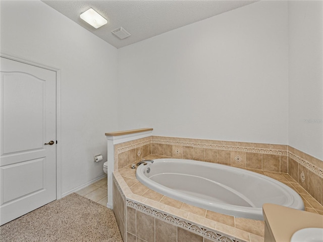 bathroom featuring visible vents, toilet, a textured ceiling, and a bath