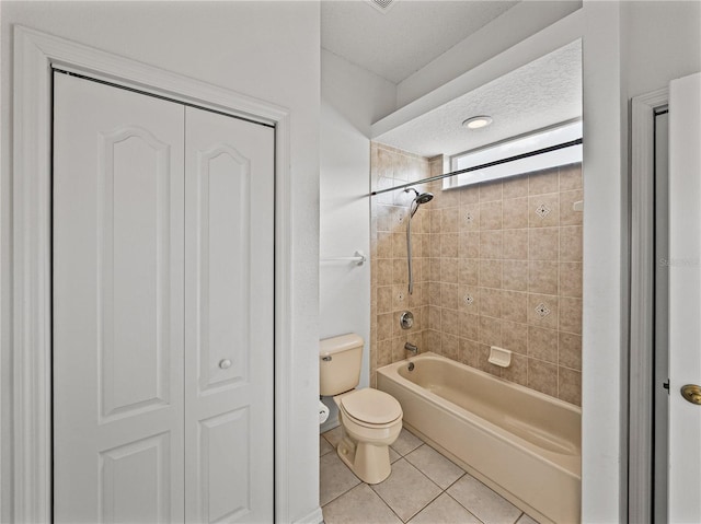 bathroom featuring tub / shower combination, toilet, tile patterned flooring, and a closet