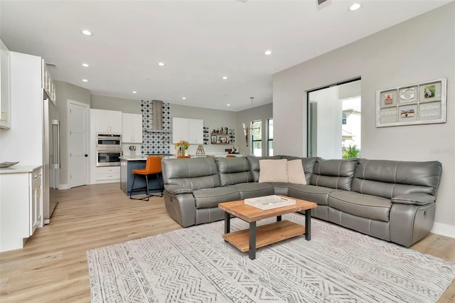 living area featuring recessed lighting and light wood-style flooring