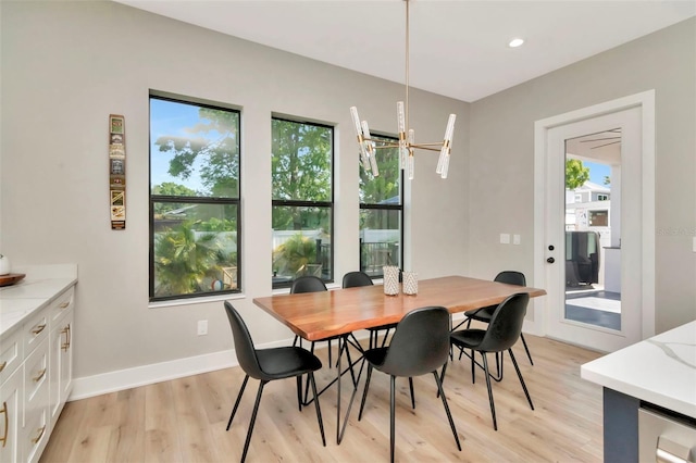 dining room featuring recessed lighting, an inviting chandelier, light wood-style flooring, and baseboards