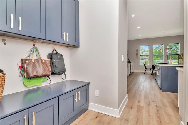 mudroom featuring baseboards, recessed lighting, and light wood finished floors