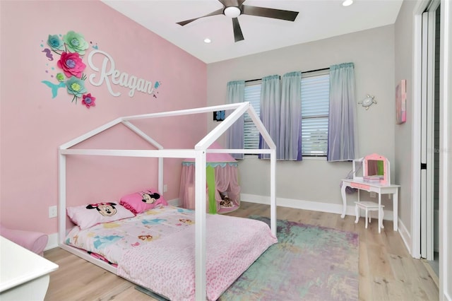 bedroom featuring wood finished floors, recessed lighting, and baseboards