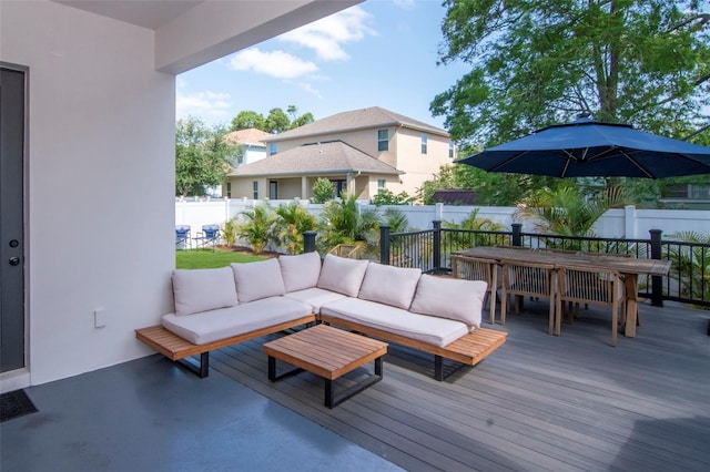 deck featuring outdoor dining space, outdoor lounge area, and a fenced backyard
