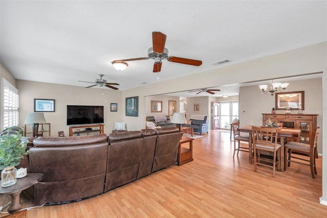 9335 Stonewall, New Port Richey, FL 34655 - living room featuring light wood-style flooring, ceiling fan, and a chandelier