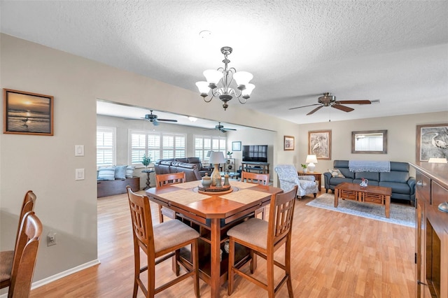 9335 Stonewall, New Port Richey, FL 34655 - dining area featuring ceiling fan, light wood-type flooring, a textured ceiling, a chandelier, and baseboards