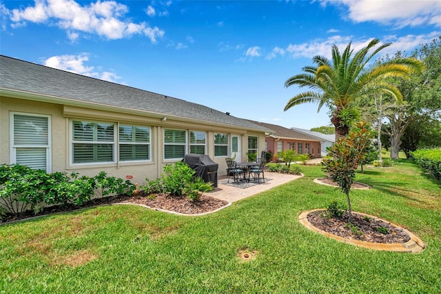 9335 Stonewall, New Port Richey, FL 34655 - back of house with stucco siding, a patio area, and a yard