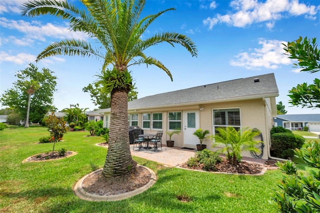 9335 Stonewall, New Port Richey, FL 34655 - back of property featuring a patio area, a yard, and stucco siding