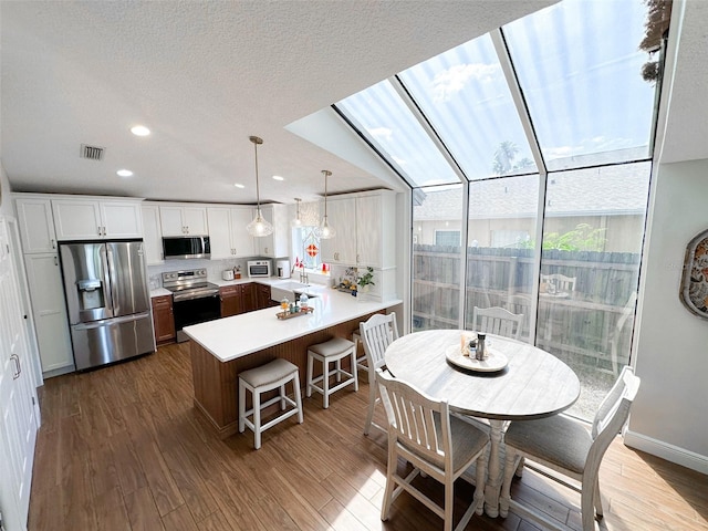 dining room featuring visible vents, recessed lighting, and dark wood finished floors