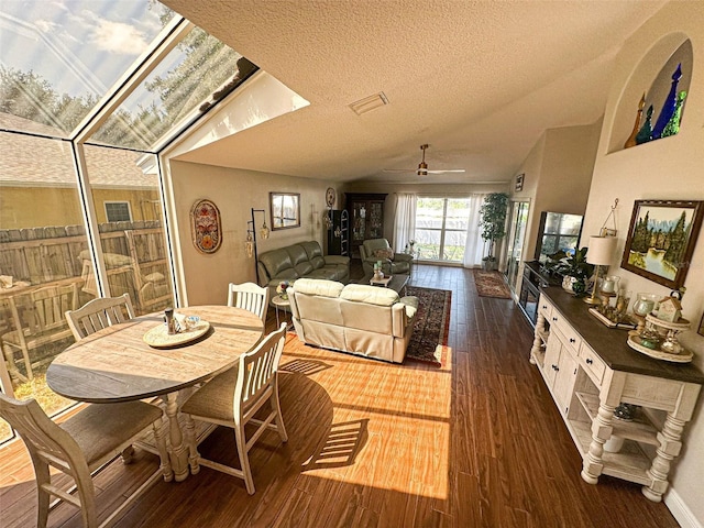 dining room featuring a textured ceiling, visible vents, a ceiling fan, and dark wood finished floors