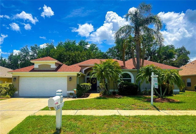 923 Tuscanny St, Brandon, FL 33511 - mediterranean / spanish house with stucco siding, an attached garage, concrete driveway, and a front yard