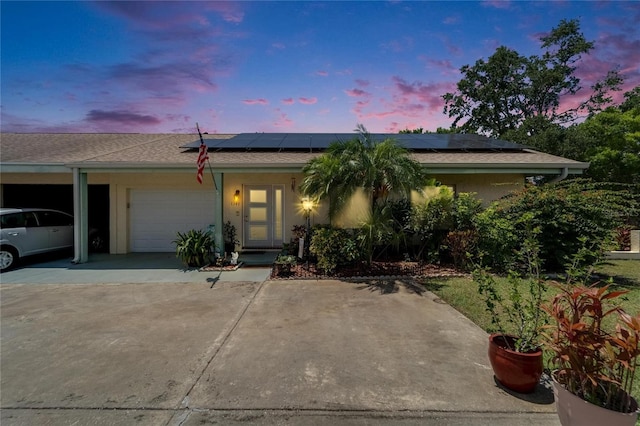 1349 New Bedford Dr Unit 6, Sun City Center, FL 33573 - single story home featuring an attached garage, solar panels, and driveway