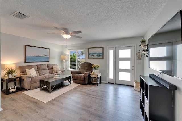 1349 New Bedford Dr Unit 6, Sun City Center, FL 33573 - living room featuring a textured ceiling, ceiling fan, and wood finished floors