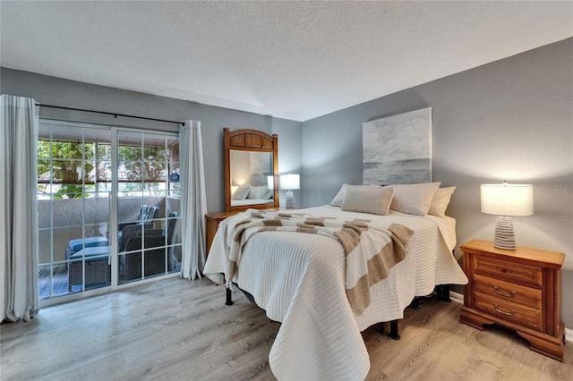 1349 New Bedford Dr Unit 6, Sun City Center, FL 33573 - bedroom featuring access to exterior, wood finished floors, and a textured ceiling
