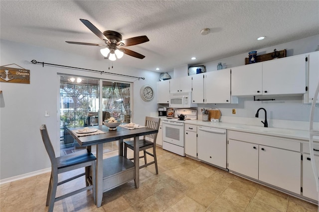 1349 New Bedford Dr Unit 6, Sun City Center, FL 33573 - kitchen featuring white appliances, ceiling fan, a sink, light countertops, and white cabinetry