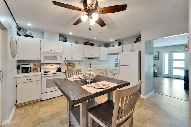 1349 New Bedford Dr Unit 6, Sun City Center, FL 33573 - kitchen featuring white appliances, a textured ceiling, light countertops, a ceiling fan, and white cabinets