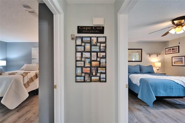 1349 New Bedford Dr Unit 6, Sun City Center, FL 33573 - bedroom with wood finished floors, a textured ceiling, and ceiling fan