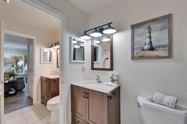 1349 New Bedford Dr Unit 6, Sun City Center, FL 33573 - bathroom with toilet, two vanities, and tile patterned flooring
