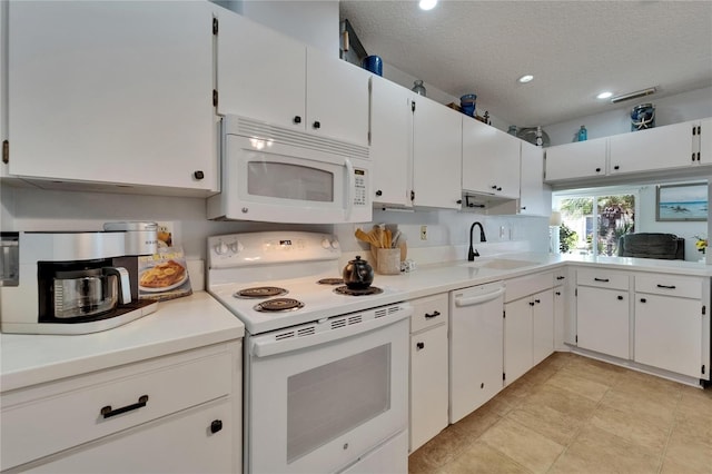1349 New Bedford Dr Unit 6, Sun City Center, FL 33573 - kitchen featuring white appliances, a sink, a textured ceiling, light countertops, and white cabinets