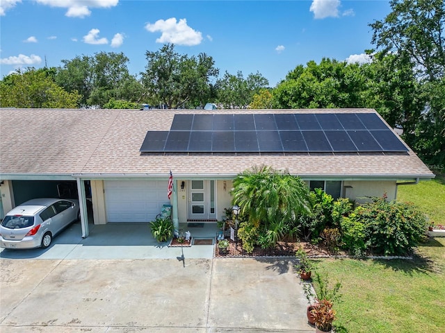 1349 New Bedford Dr Unit 6, Sun City Center, FL 33573 - single story home featuring an attached garage, roof mounted solar panels, driveway, and roof with shingles