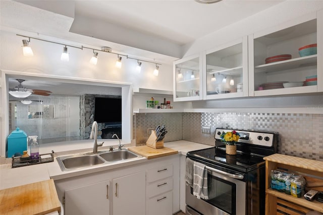 kitchen with backsplash, open shelves, light countertops, a sink, and stainless steel electric stove