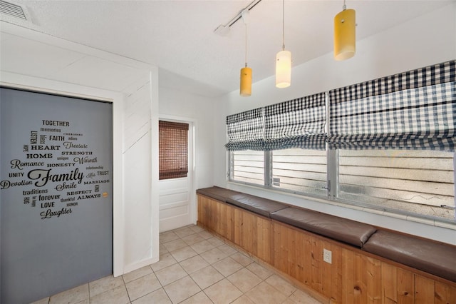 interior space with visible vents, track lighting, and light tile patterned floors