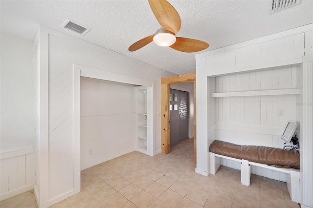 unfurnished bedroom with visible vents, a textured ceiling, ceiling fan, and light tile patterned floors