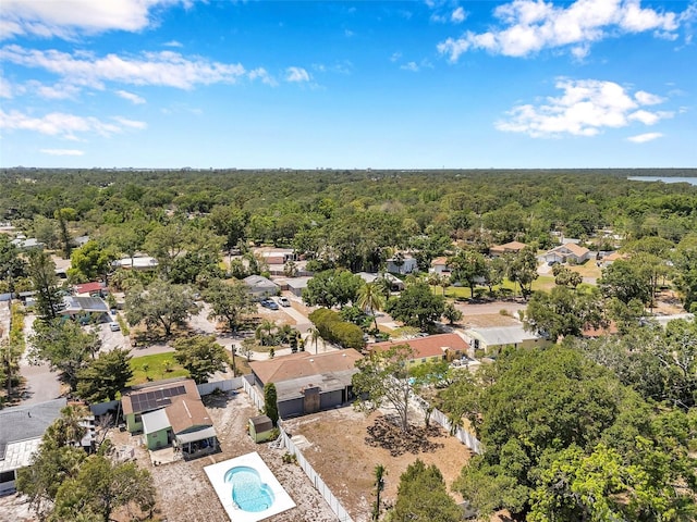 drone / aerial view with a residential view and a wooded view