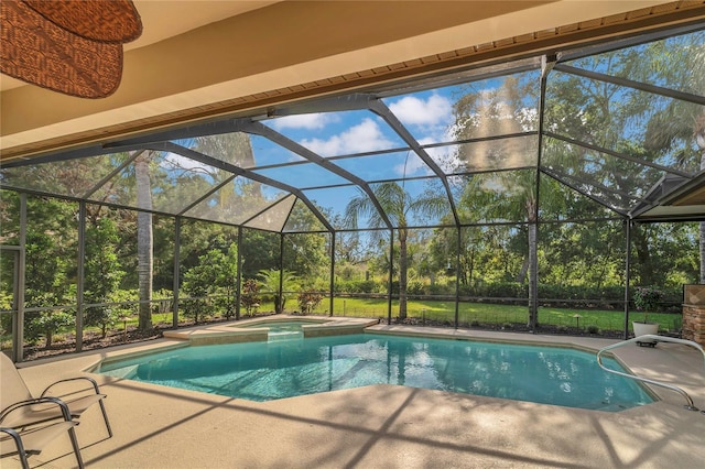 view of swimming pool featuring a patio, a pool with connected hot tub, and a lanai