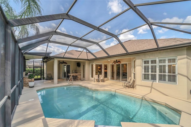 outdoor pool featuring ceiling fan, a patio area, and a lanai