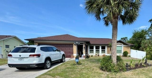 150 Tompkins St, Port Charlotte, FL 33954 - ranch-style home featuring a garage, fence, driveway, and a front yard
