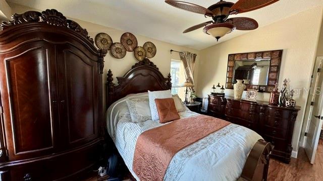 150 Tompkins St, Port Charlotte, FL 33954 - bedroom with lofted ceiling, wood finished floors, and a ceiling fan