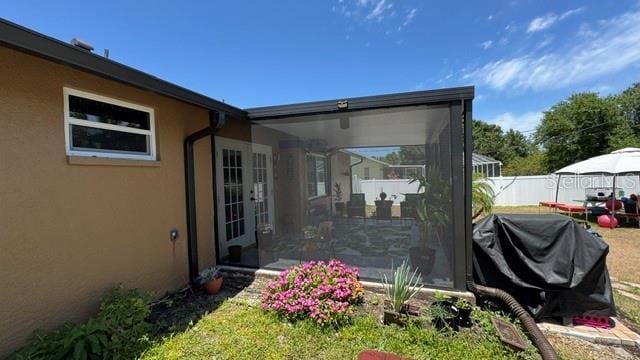 150 Tompkins St, Port Charlotte, FL 33954 - exterior space with stucco siding, fence, and french doors