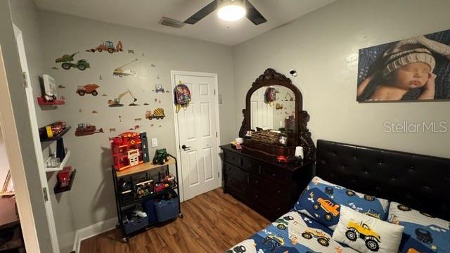 150 Tompkins St, Port Charlotte, FL 33954 - bedroom with a ceiling fan, visible vents, and wood finished floors
