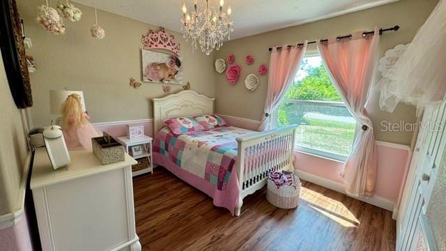 150 Tompkins St, Port Charlotte, FL 33954 - bedroom featuring an inviting chandelier, wood finished floors, and baseboards