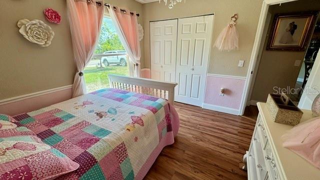 150 Tompkins St, Port Charlotte, FL 33954 - bedroom featuring baseboards, wood finished floors, and a closet