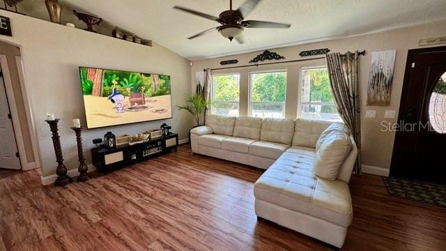 150 Tompkins St, Port Charlotte, FL 33954 - living room with baseboards, wood finished floors, ceiling fan, and vaulted ceiling