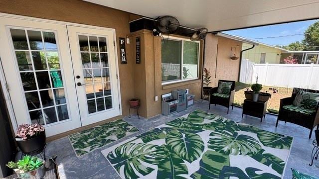 150 Tompkins St, Port Charlotte, FL 33954 - doorway to property with a patio, stucco siding, french doors, and fence