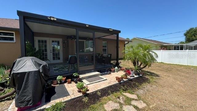 150 Tompkins St, Port Charlotte, FL 33954 - back of property featuring fence, french doors, and stucco siding