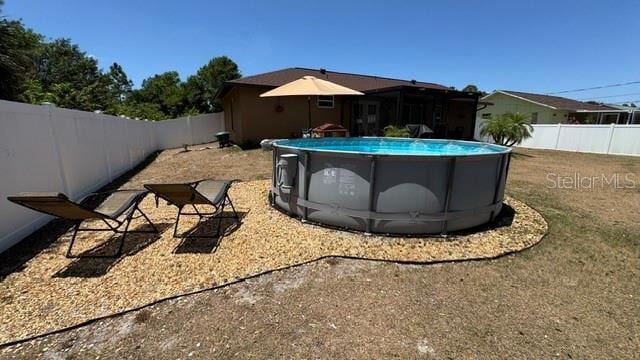 150 Tompkins St, Port Charlotte, FL 33954 - view of yard featuring a fenced in pool and a fenced backyard