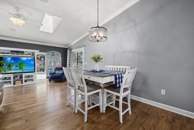dining space featuring ornamental molding, a textured wall, wood finished floors, vaulted ceiling with skylight, and ceiling fan with notable chandelier