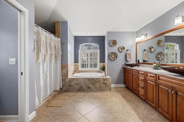 bathroom featuring a garden tub, double vanity, baseboards, tile patterned floors, and a shower with curtain