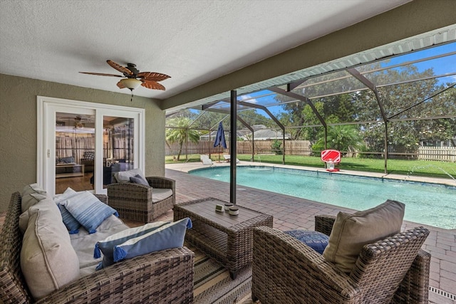 view of pool with ceiling fan, a patio, a fenced backyard, an outdoor living space, and a fenced in pool